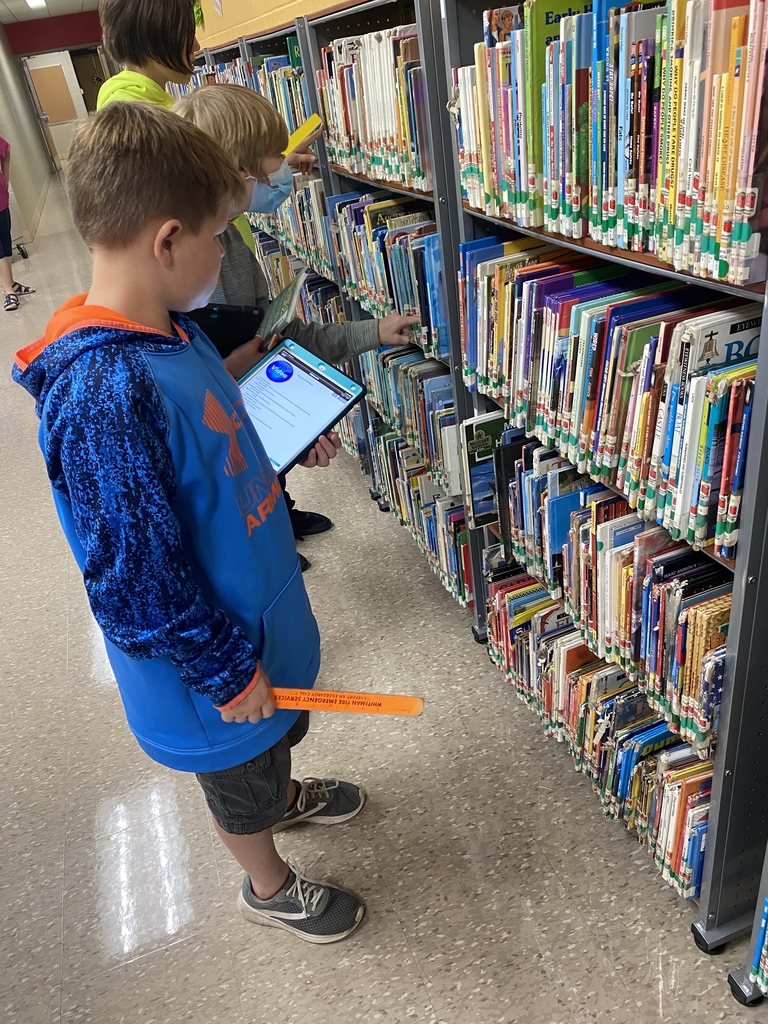 Students locating library books.